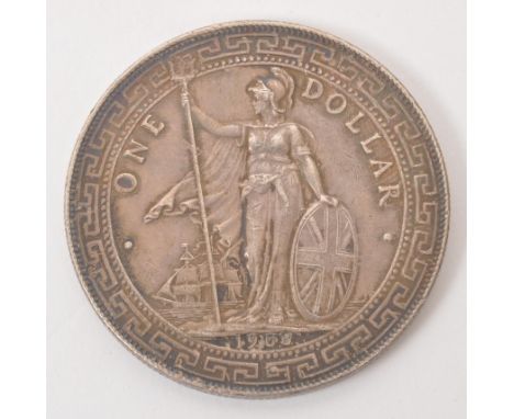 A Bombay mint silver British Trade Dollar. The obverse featuring the figure of Britannia stood, holding a trident (with Bomba