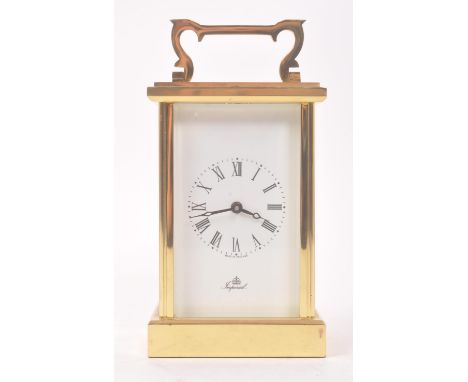 A 20th century Imperial brass carriage clock, with Fema London 11 Jewels movement. The clock having a glass sided brass case,
