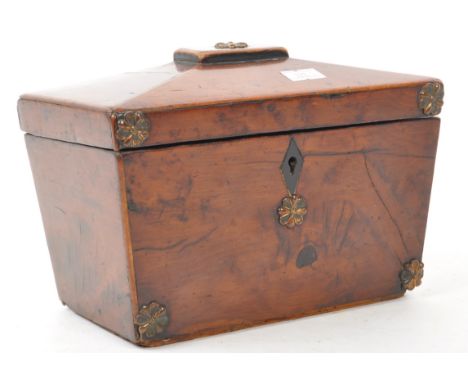 A 19th century George III walnut sarcophagus shaped tea caddy, The tea caddy having carved florals to top and opening to reve