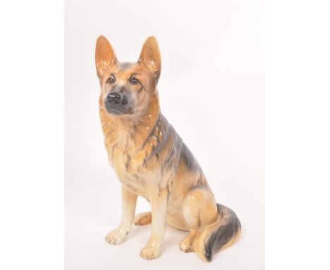 Beswick - A vintage 20th century ceramic Alsatian / German shepherd dog figurine. In a seated position in the tradition brown
