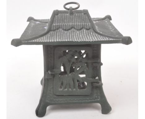 A 20th century cast iron Japanese pagoda style lantern. The lantern in the style of a Japanese Pagoda, with hinged door to si