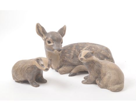 Poole pottery - 20th century - A large hand made figure of a fawn and two smaller figure badgers with textured markings in mu