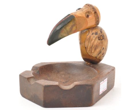 A 20th Century novelty wooden ashtray in the form of a bird / pelican in the manner of Henry Howell. The base having cigarett