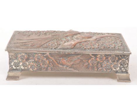 An early 20th Century circa 1920s silver plated Japanese trinket box having relief cherry blossom and bird design upon bracke