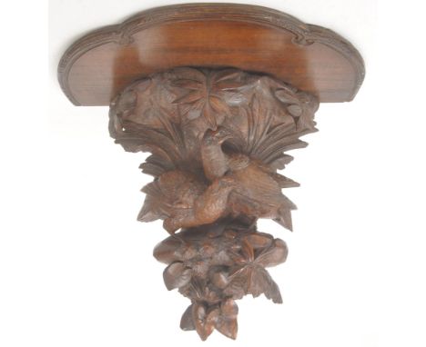 Black Forest wooden carved wall sconce / shelf. Early 20th century with half circular platform to top, with carved foliate an
