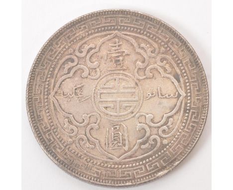 A Bombay mint silver British Trade Dollar. The obverse featuring the figure of Britannia stood, holding a trident (with Bomba