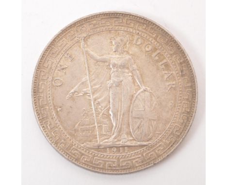 A Bombay mint silver British Trade Dollar. The obverse featuring the figure of Britannia stood, holding a trident (with Bomba