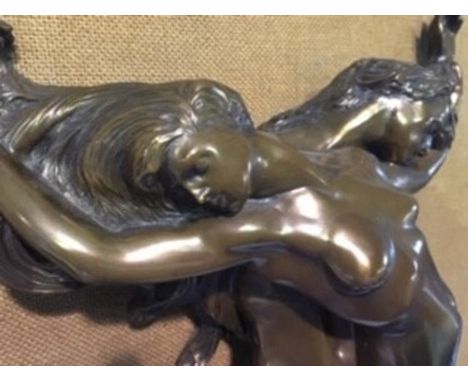 A relief sculpture of an entwined man and woman, mounted on board
