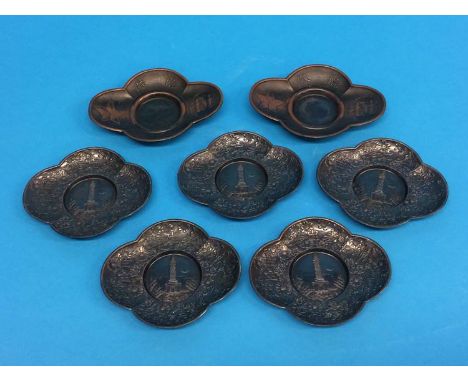Two Japanese Imperial army metal sake saucers and a set of five saucers each depicting the Russo-Japan War Monument at Port A