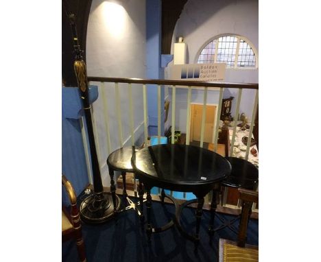 An ebonised nest of three tables and a standard lamp