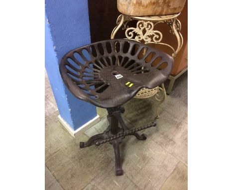 A tractor seat style stool and a plant stand