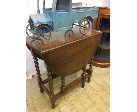 An oak barley twist gate leg table