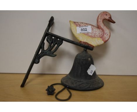 A wall mounted cast iron doorbell having duck design.