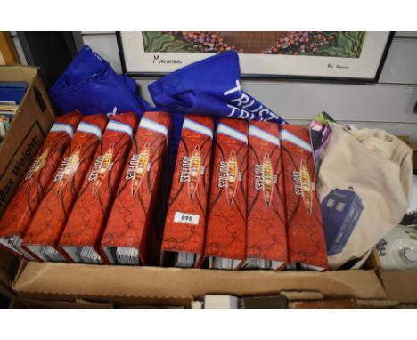 A shelf containing eight Doctor Who DVD Files, all full, along with eight reusable bags/bin
