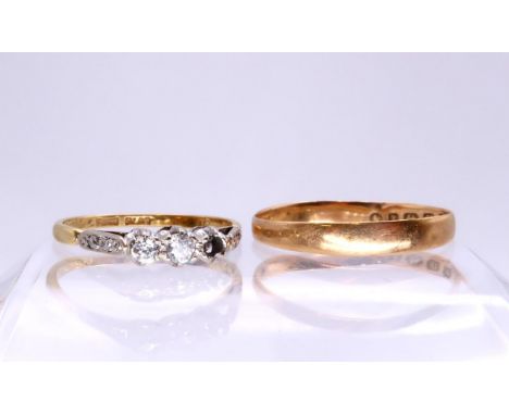 An 18ct gold three stone diamond ring, size N, (one diamond missing) together with an 18ct gold wedding ring, size R, weight 