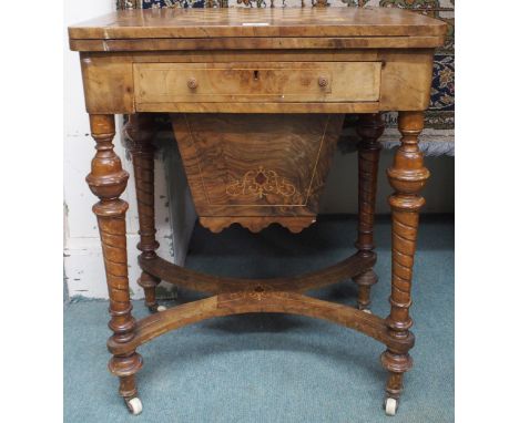 A Victorian walnut and parquetry inlaid games/sewing table with fold-over top baized lining over single sectioned drawer over