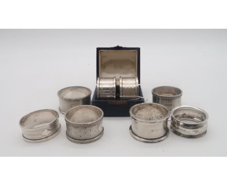 A collection of silver napkin rings, including a cased pair by Henry Griffith &amp; Sons, Birmingham, another pair by Walker 