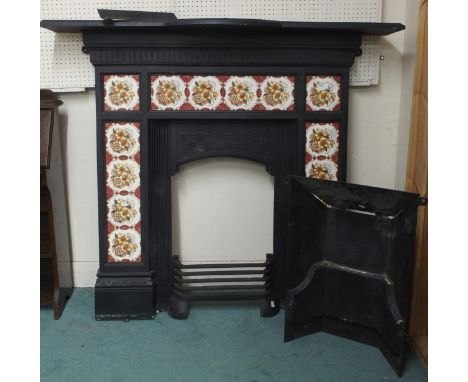 A 19th century cast iron combination fireplace/insert with iron mantle over floral tile inset surround, 130cm high x 142cm wi