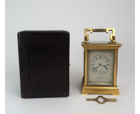 A 19th century French brass and glass carriage clock&nbsp; with silvered dial, and roman numerals, retailed by Edward of Glas