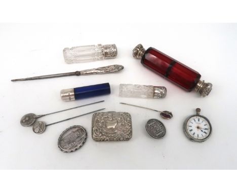 A collection of silver and white metal including a ruby glass and white metal mounted double ended scent bottle, two clear gl