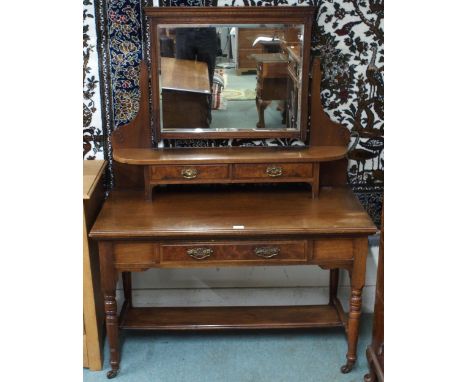 A late Victorian mahogany mirror backed dressing table on turned supports terminating in ceramic casters, 144cm high x 108cm 