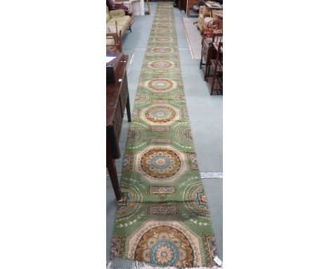 A green ground Axminster style stair runner, 1162cm long x 70cm wide&nbsp; Condition Report:Available upon request
