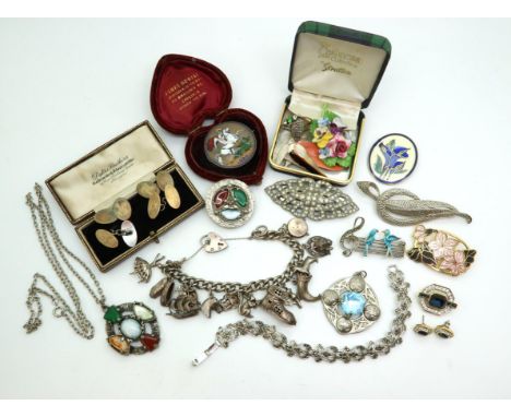 A silver charm bracelet with some good large charms to include the old woman that lived in a shoe, an enamelled 1887 silver c