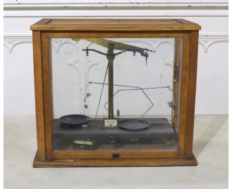 A set of precision balance scales by Griffin &amp; George Limited, housed in a glazed case measuring approx. 46.5cm wide x 40