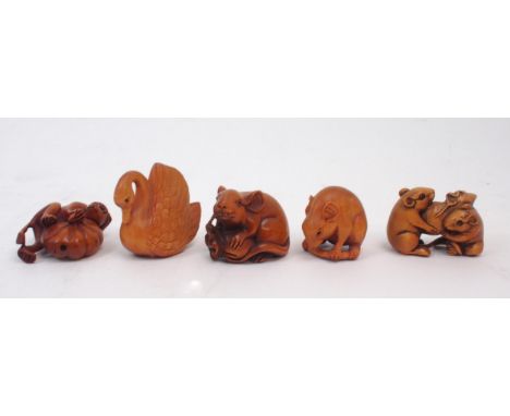 A collection of Japanese fruitwood netsuke, one carved as a swan, the other as a monkey clutching a pumpkin, two as mice, one