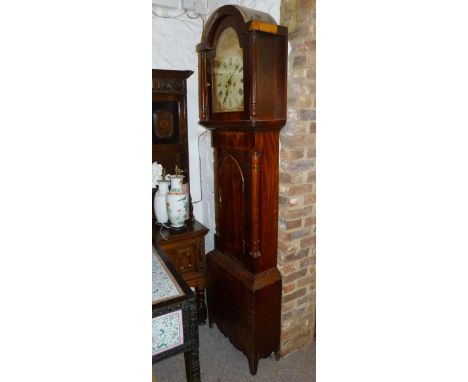 An Early 19th Century Mahogany Longcase Clock, the arched hood above an arched door raised upon low feet, the painted dial wi