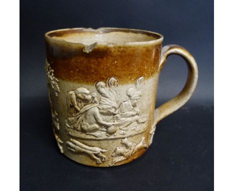A Late 17th or Early 18th Century Stoneware Hunting Mug, decorated in relief with figures, hunting hounds and fox, 13.5 cms t