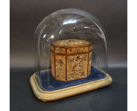 A George III Octagonal Rolled Paper Tea Caddy under a glass dome