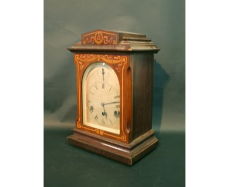 An Edwardian Mahogany Marquetry Inlaid Mantle Clock, the silvered dial with strike silent, Roman numerals and three train mov