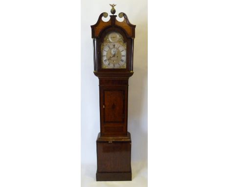 A George III Oak and Mahogany Cross Banded Long Case Clock, the arched hood with swan neck pediment and brass cresting above 