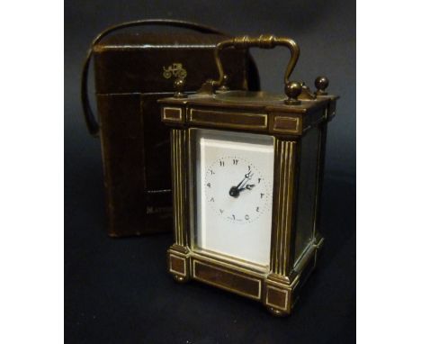 An Edwardian Brass Cased Small Carriage Clock, retailed by Matthew Norman, London, the enamel dial with Arabic numerals and w