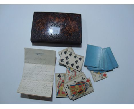 An Ecarte card game, the burr wood box with cut steel decoration, opening to reveal various early 19th Century playing cards 