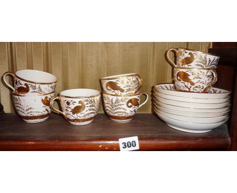 Seven early 19th c. English china cups and saucers, with gilt lustre birds decoration