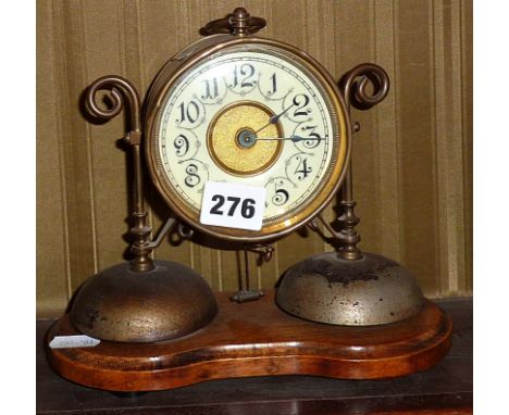 Unusual early 20th c. swing pendulum brass mantle alarm clock on wood plinth, the Junghans movement striking on two bells (ne