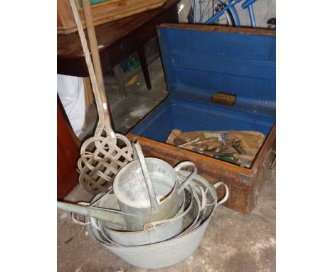 Three galvanised tin baths, a bucket, a watering can, a tin trunk &amp; contents, a carpet beater &amp; a child's rake