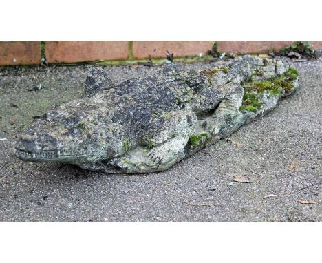 A nicely weathered reconstituted stone model of an alligator, 84cm