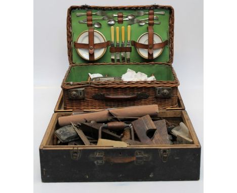 A vintage travelling picnic set, for four people fitted with cutlery and earthenware cup, saucers and plates