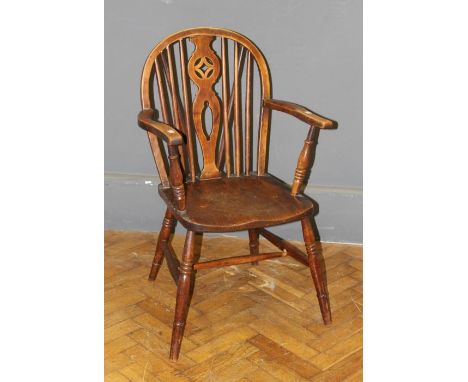 A 19th century beech and elm wheel and stick back Windsor armchair, with saddle seat on ring turned splayed supports