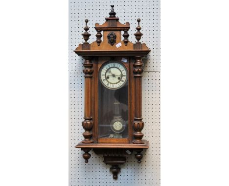 A late 19th century walnut cased Vienna wall clock, the twin train gong striking movement faced by Ivorine Roman dial, 92cm