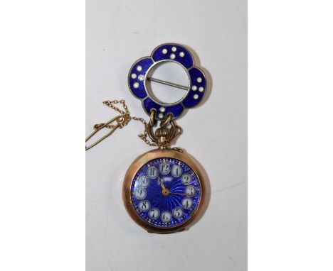 A yellow metal ladies watch, with an attractive blue guilloche dial with Roman numerals in white cloisonne circles. Inside th