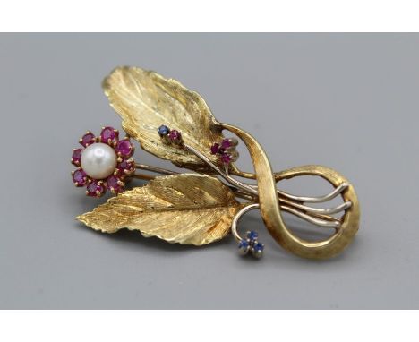 A ruby, sapphire and cultured pearl set spray brooch in yellow metal, stamped 14k to the pin, gross weight approximately 10.3
