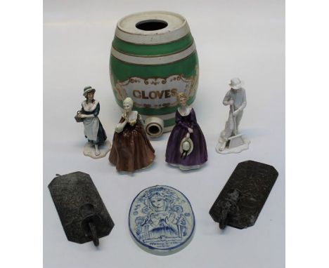 An early 20th century ceramic spirit flask, banded in green, named Cloves in gilt, four late 20th century bone china figurine