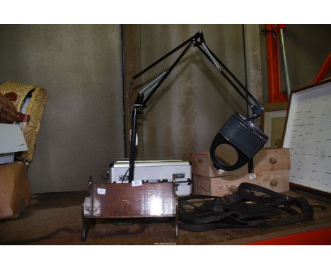 An angle-poise magnifying hobby light and a book rack.