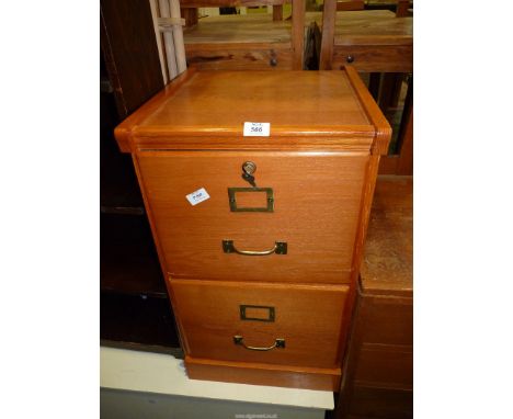 A light wood two drawer filing cabinet with suspension files, 70' cms tall.