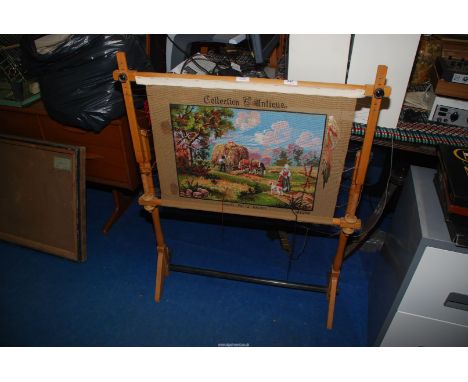 A large tapestry (not complete) on an adjustable embroidery frame.