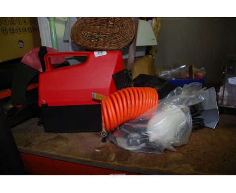 A 240 volt electric air compressor with coiled air hose, spray-gun, tyre inflator with integral pressure gauge and an exterio